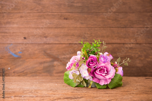 Vintage rose bouquet on wood background © ittipol
