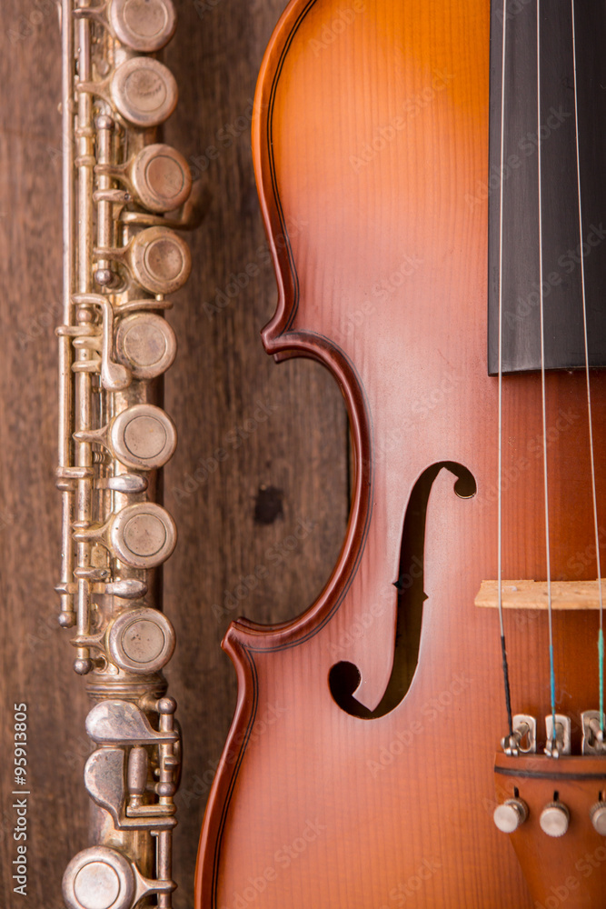 Fototapeta premium violin and flute in vintage style on wood background