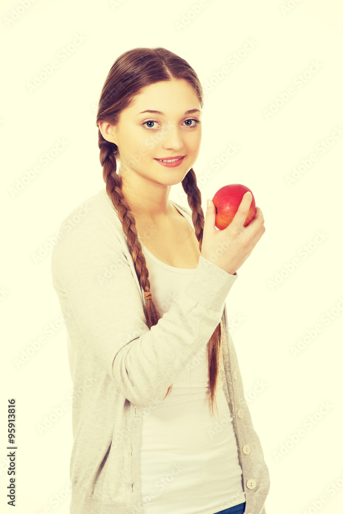Teenage woman holding an apple. Teenage woman holding an apple.