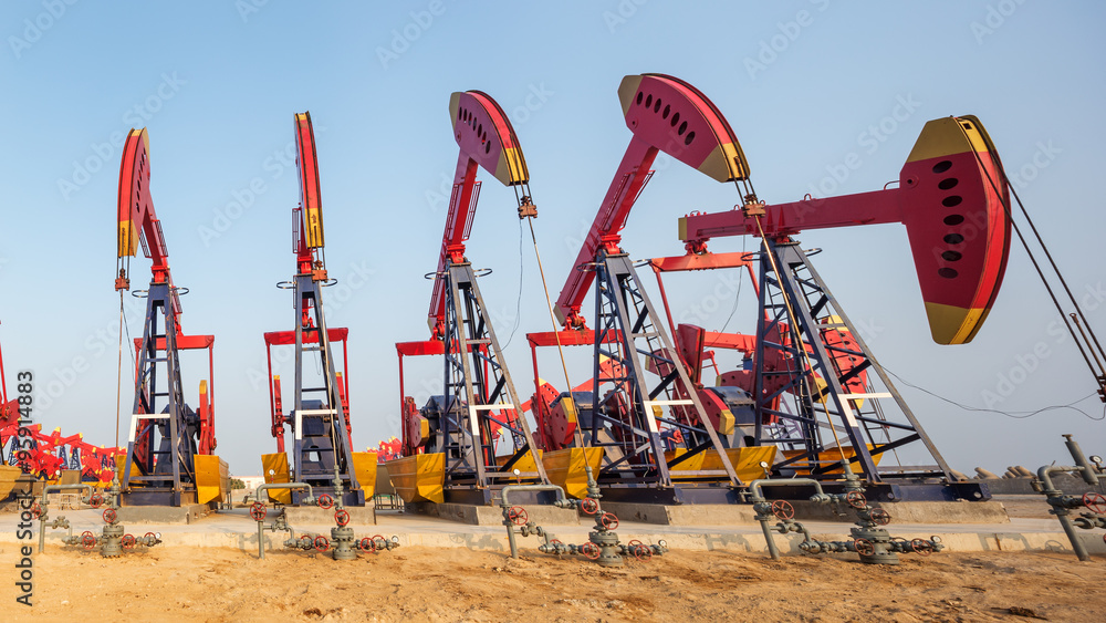 landscape of oilfield with pump units in blue sky