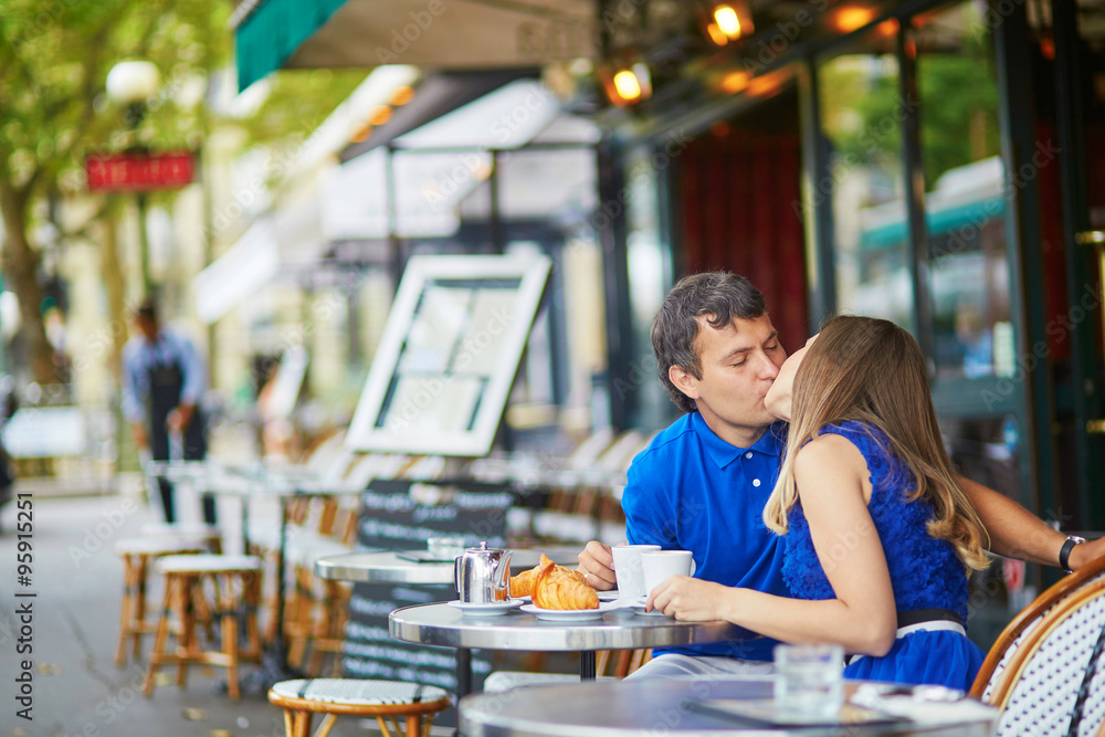 Beautiful young dating couple in Parisian cafe Beautiful young dating couple in Parisian cafe