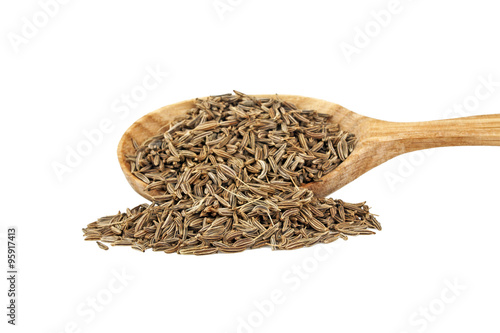 Сumin seeds in wooden spoon on white background