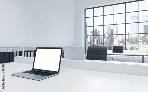 Workplaces in a bright modern loft open space office. Tables equipped with laptops, white copy space in the screen. Docs shelves. New York view in the panoramic windows. 3D rendering. © ImageFlow