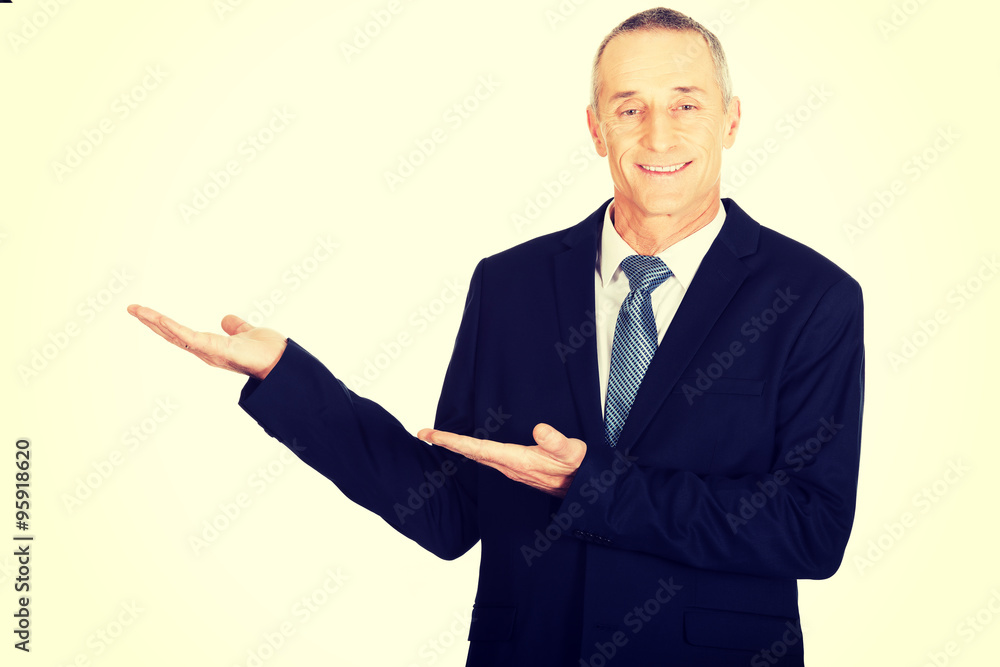 Portrait of businessman with welcome gesture Portrait of businessman with welcome gesture
