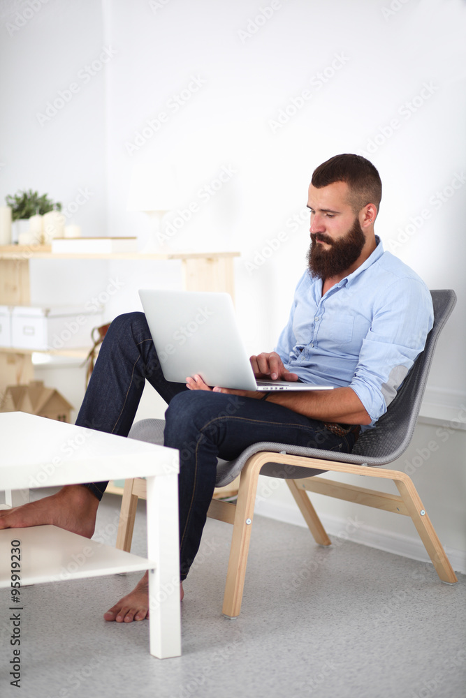 Young businessman sitting on chair in office Young businessman sitting on chair in office