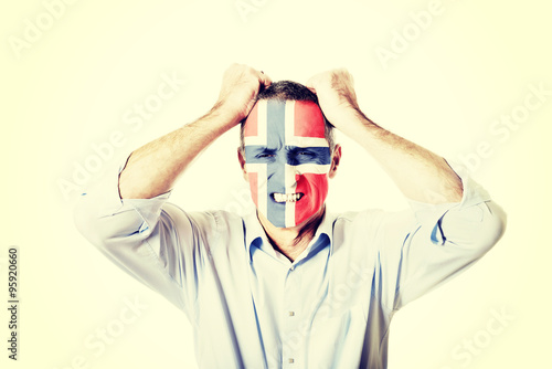Mature man with Norway flag on face. © Piotr Marcinski