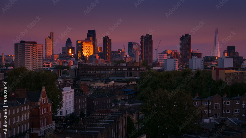 A sunset to night timelapse transition showing the famous London, UK skyline, including The Shard, The Gherkin, The Cheesegrater and The Walkie Talkie landmark building of the City of London A sunset to night timelapse transition showing the famous London, UK skyline, including The Shard, The Gherkin, The Cheesegrater and The Walkie Talkie landmark building of the City of London