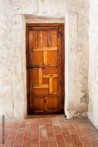 Wooden Door against Whitewashed Plaster Wall / An Interesting view of a Rustic Wooden Door against Whitewashed Plaster Wall 