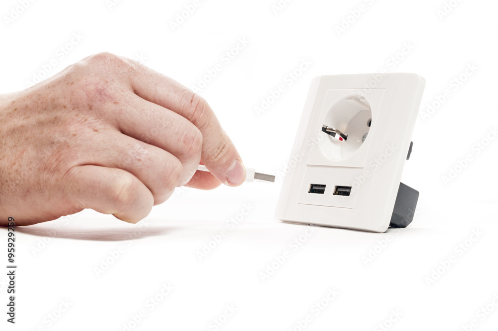 Plug in. A man stabs a usb plug into a usb port Plug in. A man stabs a usb plug into a usb port