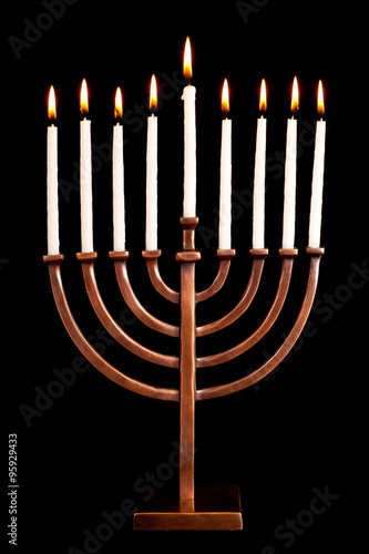 Beautiful lit hanukkah menorah on black background.