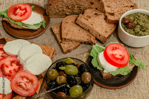 Italian food mix - mozzarella, tomatoes, olives, and bread 