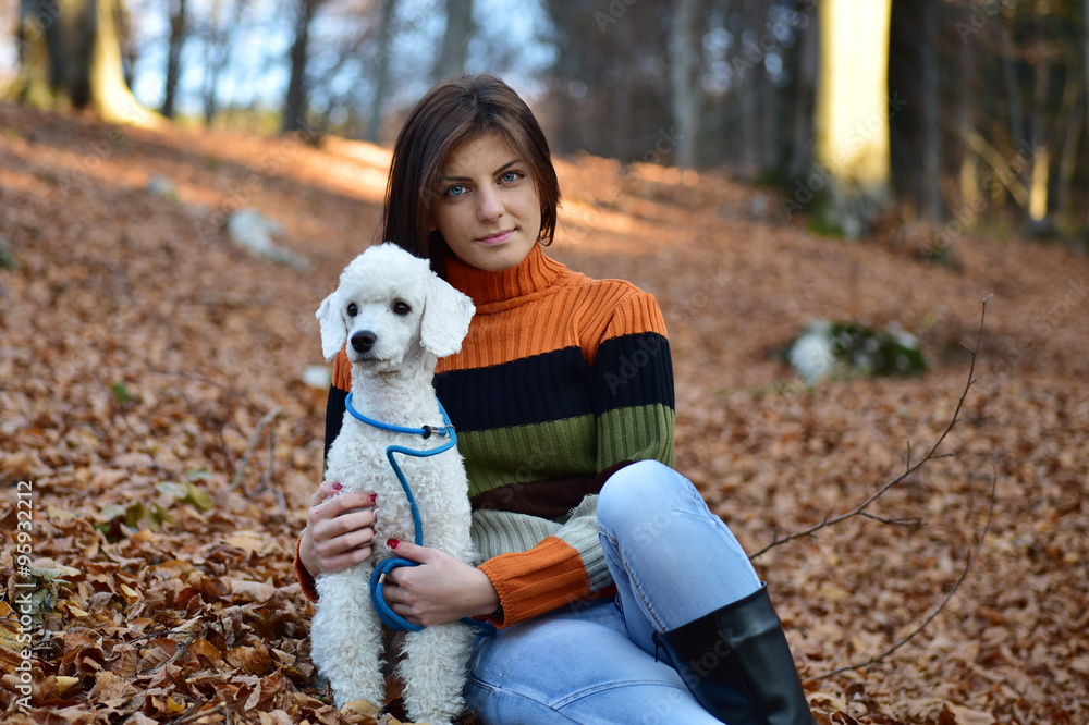 A girl with her dog in colorful autumn forest A girl with her dog in colorful autumn forest