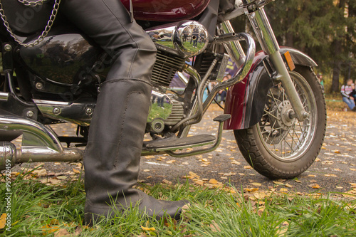 Fototapeta Naklejka Na Ścianę i Meble -  biker boots in black on a motorcycle