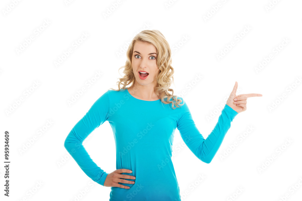 Fototapeta premium Woman pointing on copy space.