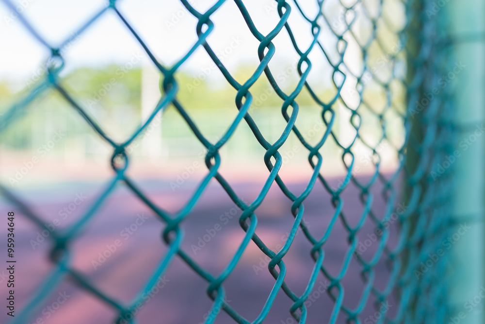 Steel mesh fence with bokeh, use selective focus