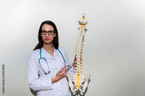 Wallpaper Mural Young doctor holding a syringe and explain about epidural and back pain   Torontodigital.ca