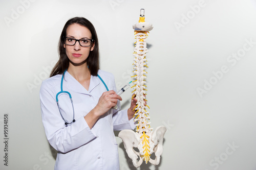 Wallpaper Mural Young doctor holding a syringe and explain about epidural and back pain     Torontodigital.ca
