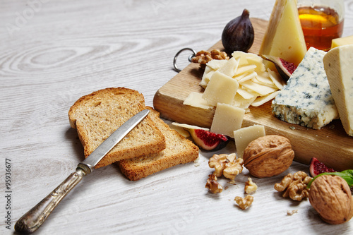 Close up Four cheeses with supplements, dried bread, figs and ot