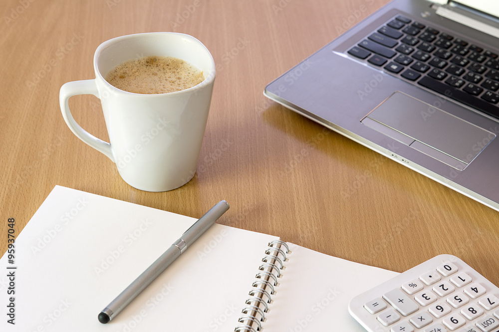 Office desk with cup of coffee and laptop computer Office desk with cup of coffee and laptop computer
