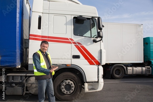 Logistics - proud driver or forwarder in drivers cap of truck