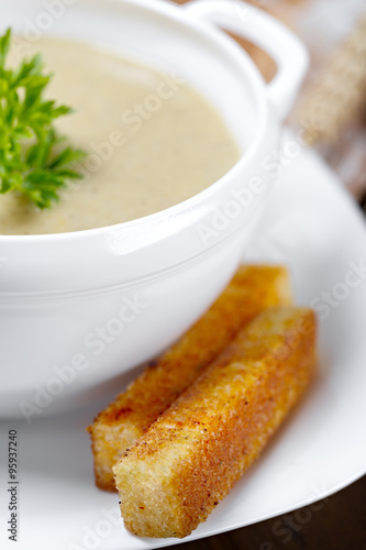Vegetable soup with parsley and fried bread.