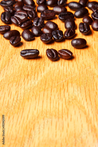whole brown coffee beans on wood