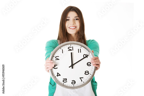 Photos Happy woman holding office clock