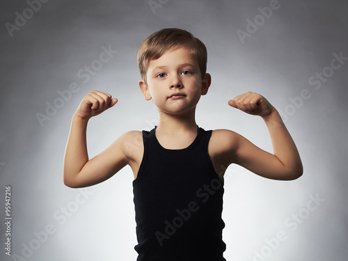 Cuadro en lienzo Child.Funny sport Little Boy showing his hand biceps muscles