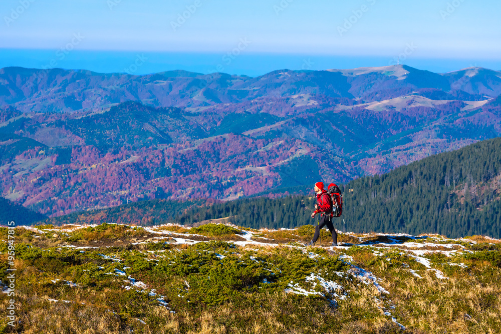 Hiker walking on Trail with Backpack Mountains View