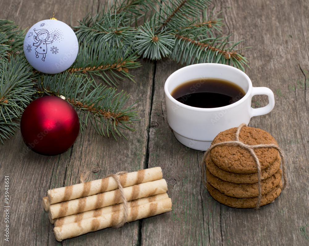 coffee, two linking of cookies and a coniferous branch with scen coffee, two linking of cookies and a coniferous branch with scen