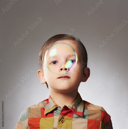 funny little boy and soap bubble.happy child