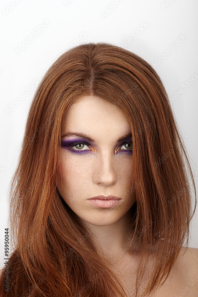 Closeup portrait of young calm beautiful redhead woman with gorgeous hair and violet eyes makeup Closeup portrait of young calm beautiful redhead woman with gorgeous hair and violet eyes makeup