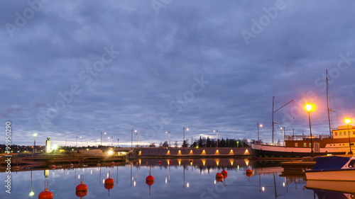 Time lapse in evening of a harbor and a bridge with cars passing by