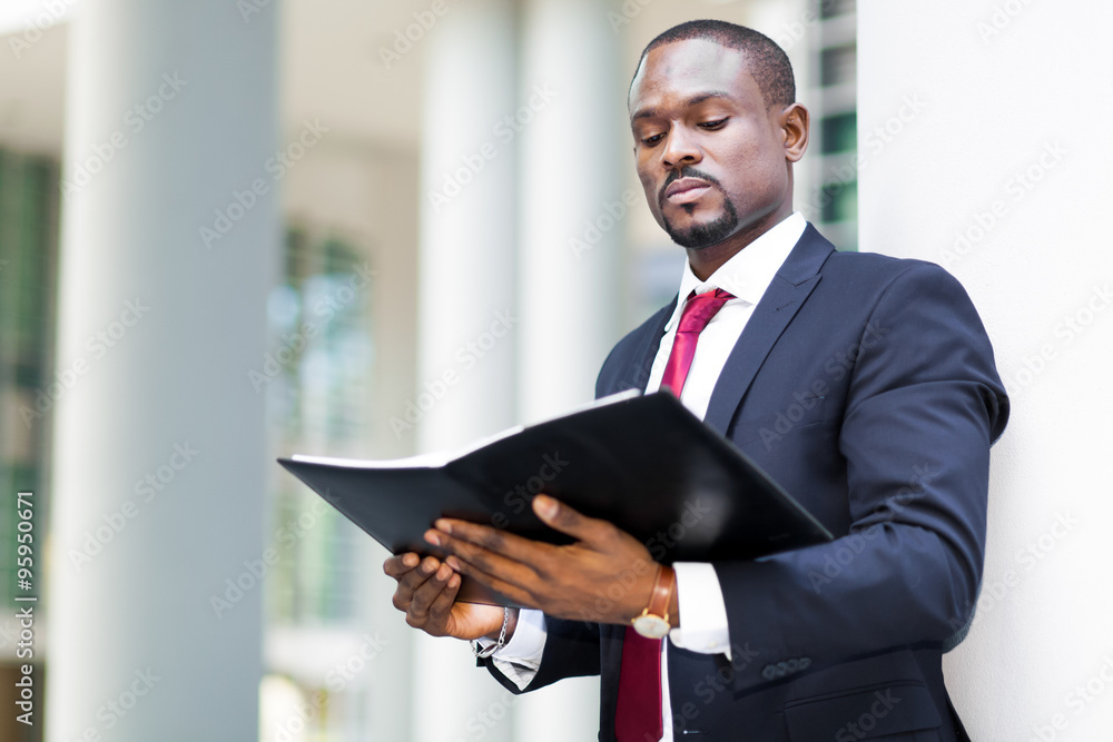 African businessman looking his agenda African businessman looking his agenda