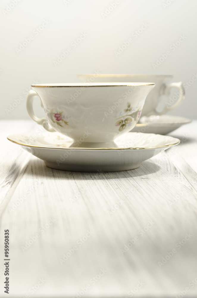 two antique teacups on white background