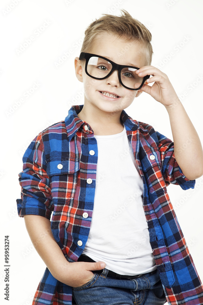 Funny child.fashionable little boy in glasses, jeans, white t-shirt and plaid shirt.stylish kid in sport shoes. fashion children