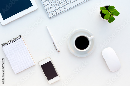Top View of White Office Desk with Modern Electronics Stationery and Flower