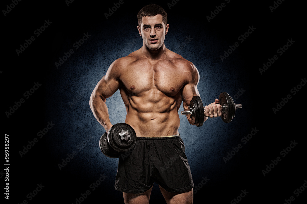 Bodybuilder doing shoulders exercises with dumbell over wall. Bodybuilder doing shoulders exercises with dumbell over wall.