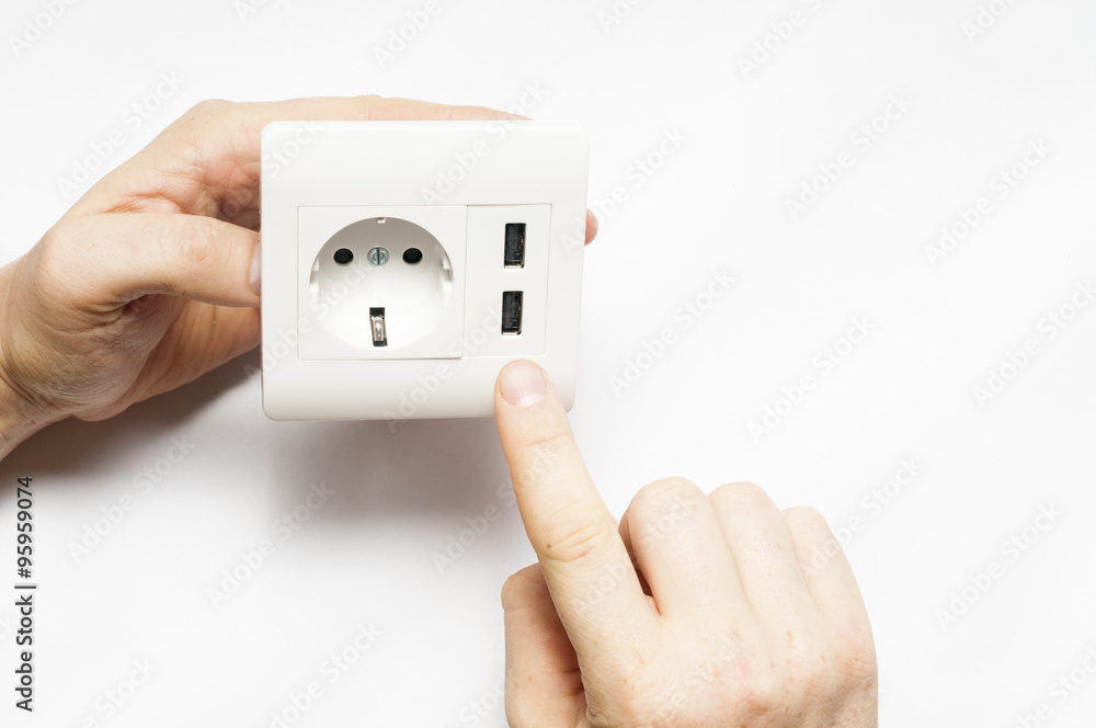A man hold the electric socket with two usb-charger ports. A man hold the electric socket with two usb-charger ports.