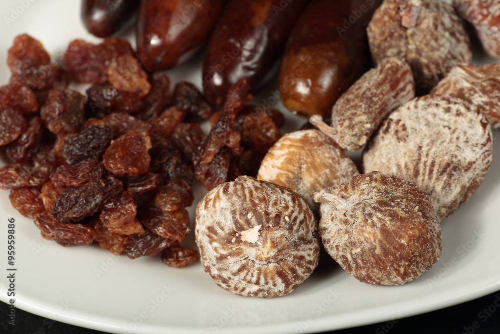 white plate with dried figs, dates and raisins white plate with dried figs, dates and raisins