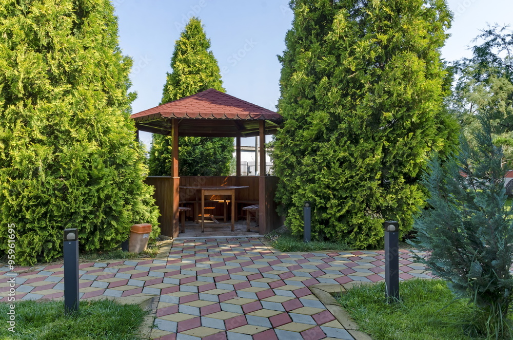 Beauty green yard with alcove with table wooden and bench for rest, Septemvri town, Pazardzhik, Bulgaria  