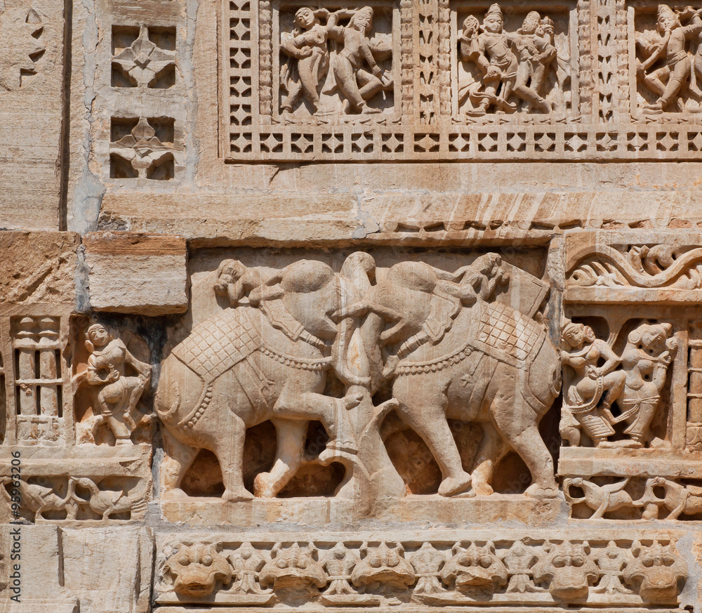 Elephants as a details of massive stone bas-relief of temple, India