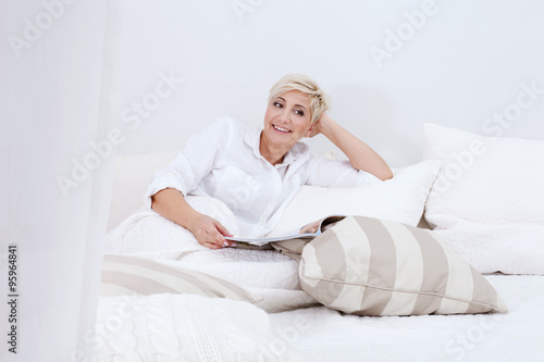 Beautiful lady relaxing in bed at the morning.