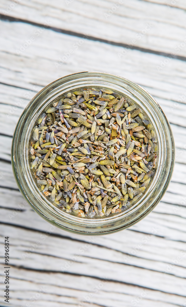 Dried lavender herbal tea in mason jar over wooden background Dried lavender herbal tea in mason jar over wooden background