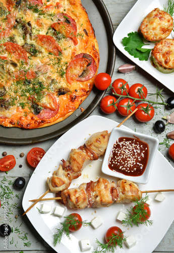 pizza kebab bbq tomatoes olives garlic on wooden rustic table