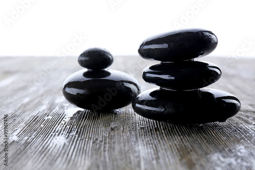 Wet spa stones on wooden table  closeup