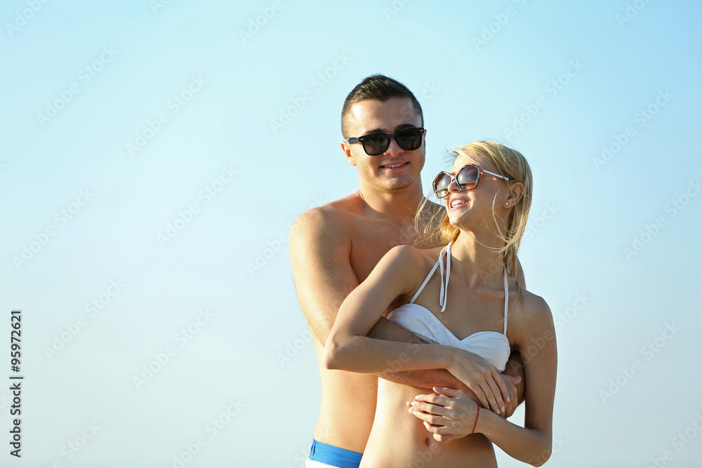 A hugging couple at the beach, outdoors A hugging couple at the beach, outdoors