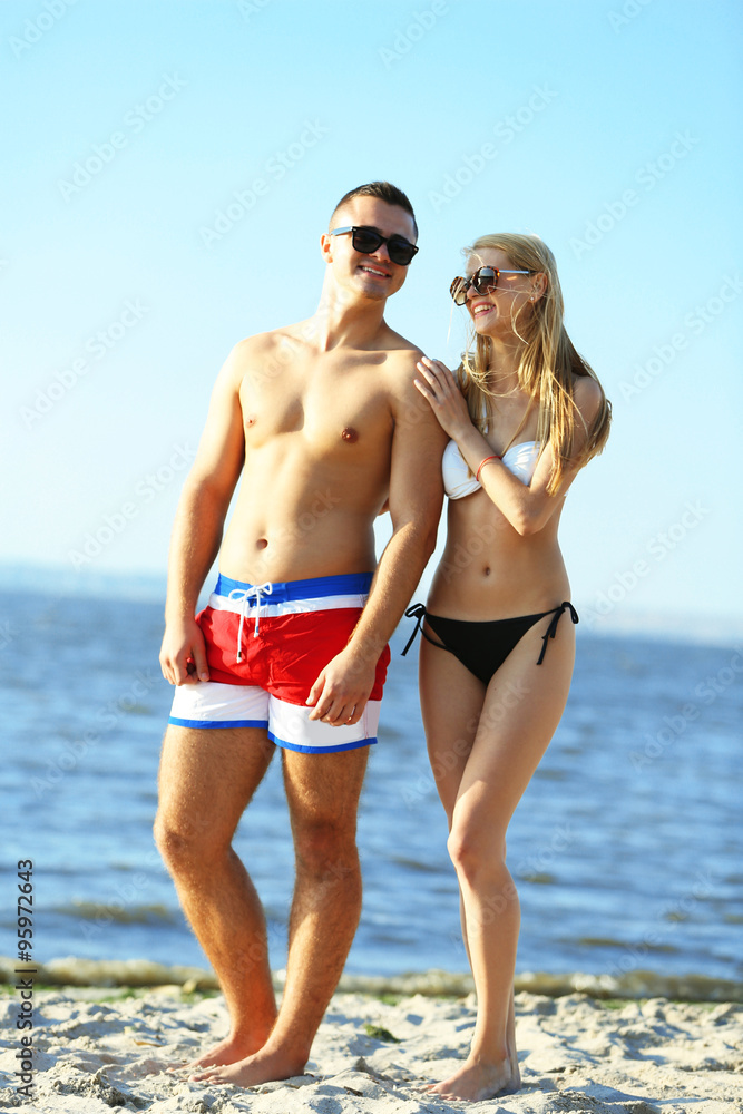 A hugging couple at the beach, outdoors