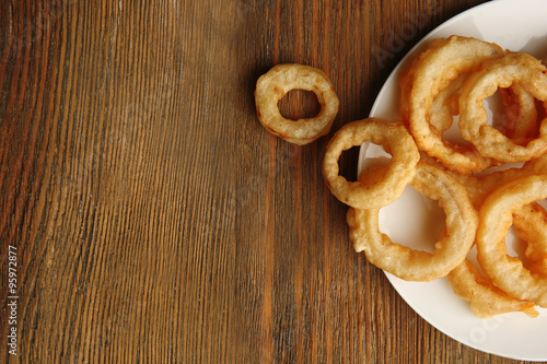 Chips rings on plate on wooden background