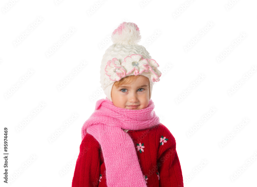 Little girl with ponytails in a warm hat and red sweater on a w Little girl with ponytails in a warm hat and red sweater on a w